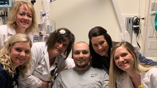 Nurse Sloane and her colleagues posing with a patient