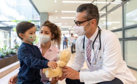 Doctor with pediatric patient and parent