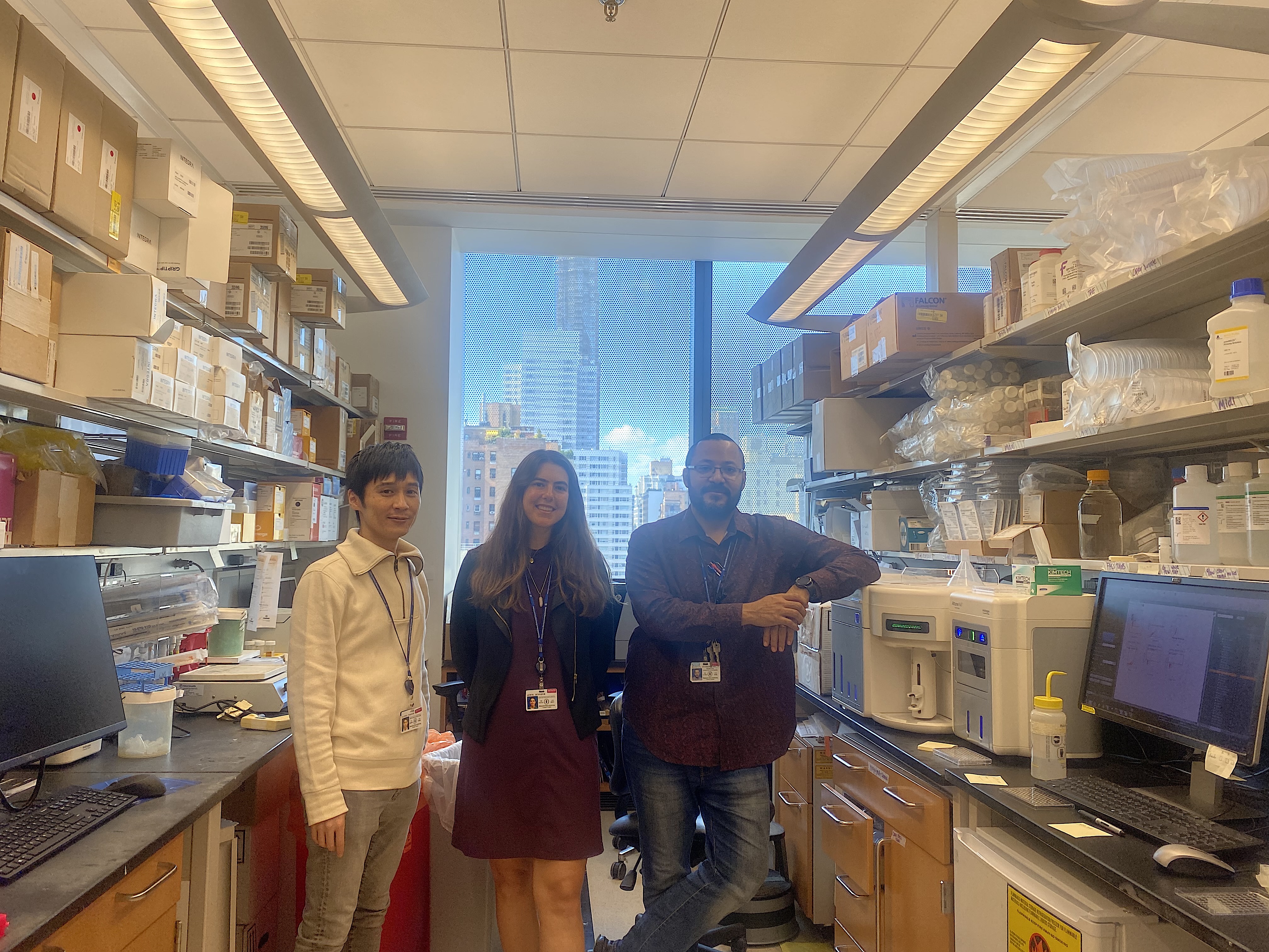 Jennifer Lewis (center) stands with Dr. Takeshi Fujino (left) and Dr. Anthony Daniyan (right). Lewis has been assisting Dr. Fujino in research.