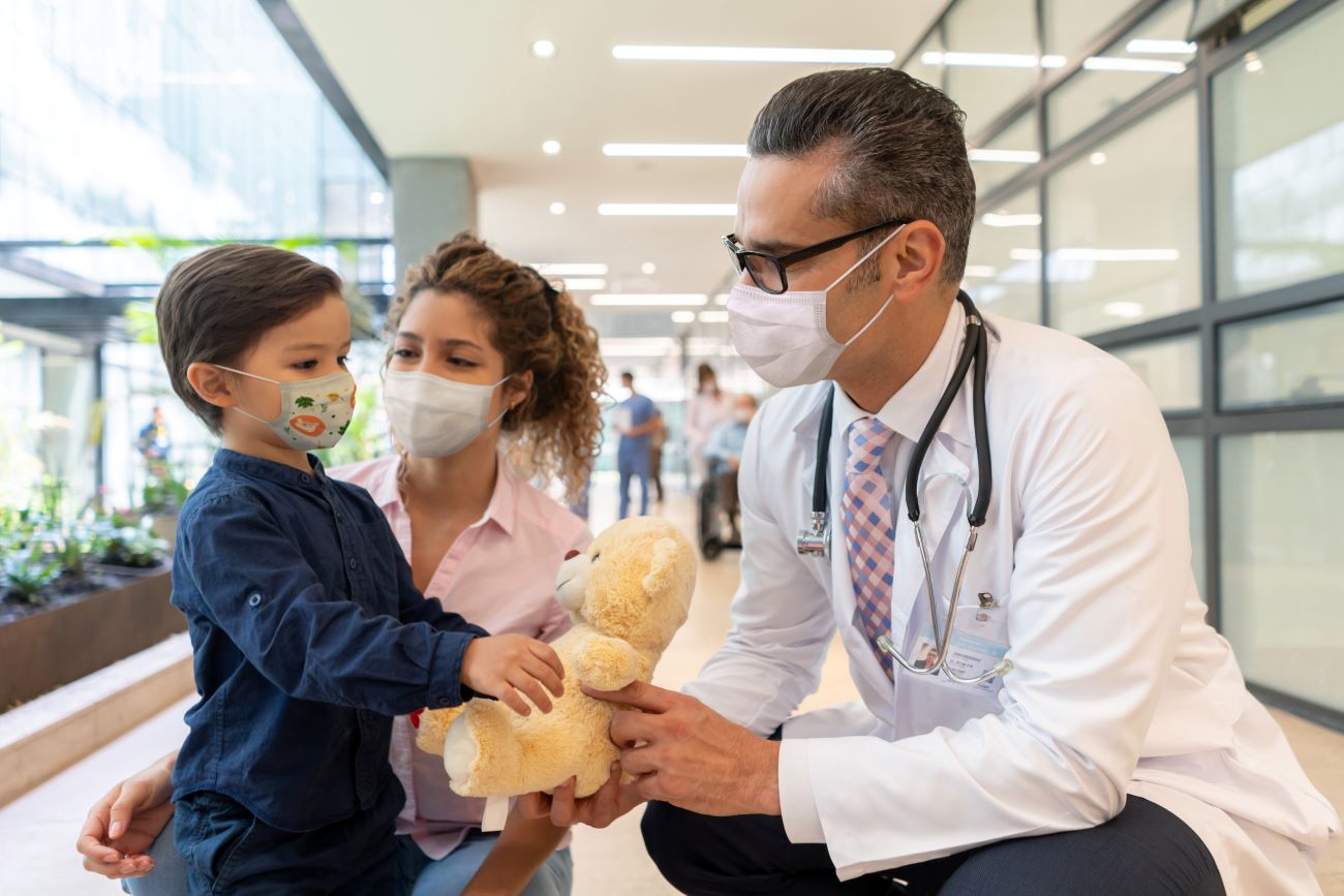 Doctor with pediatric patient and parent