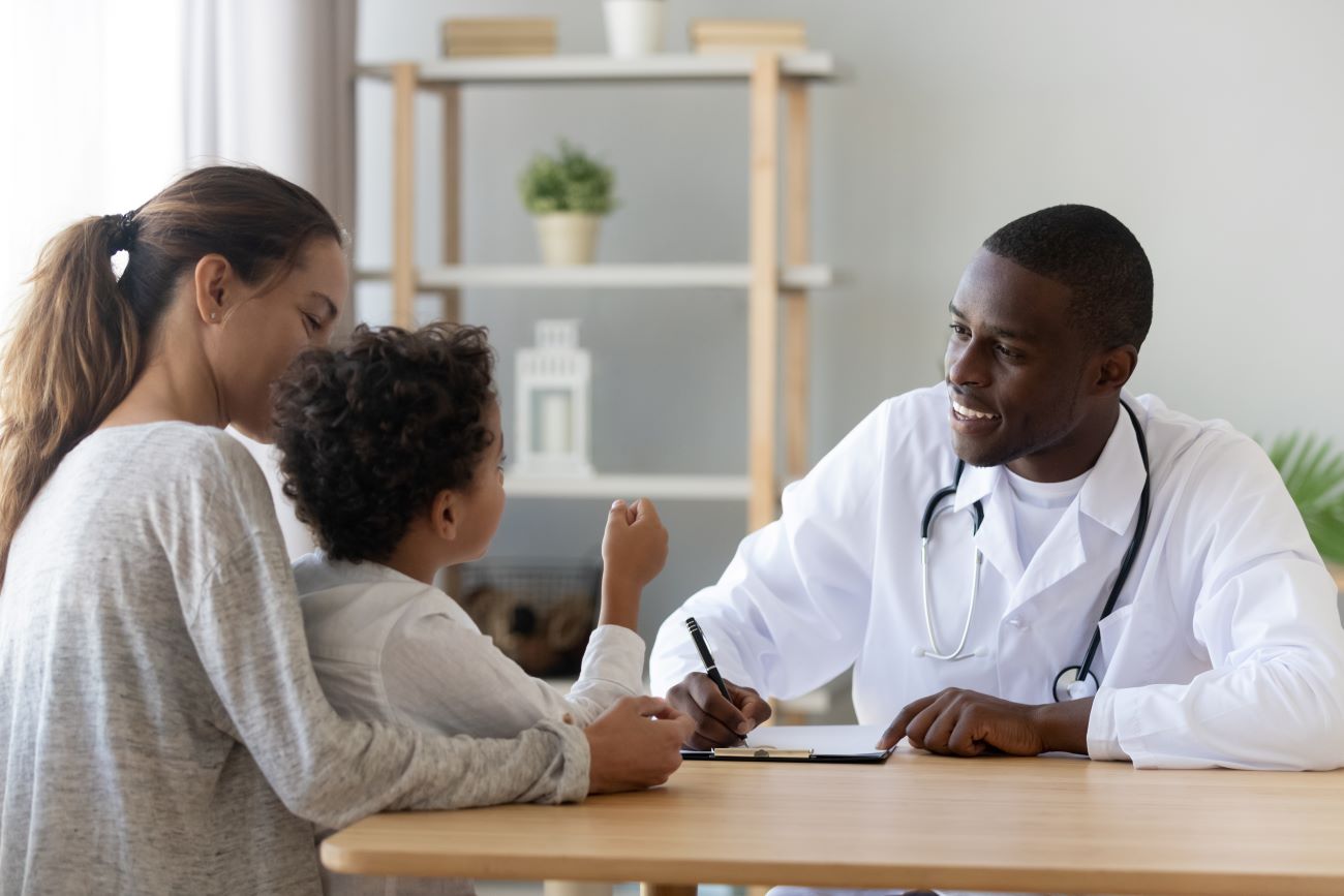 Pediatric patient and parent with doctor