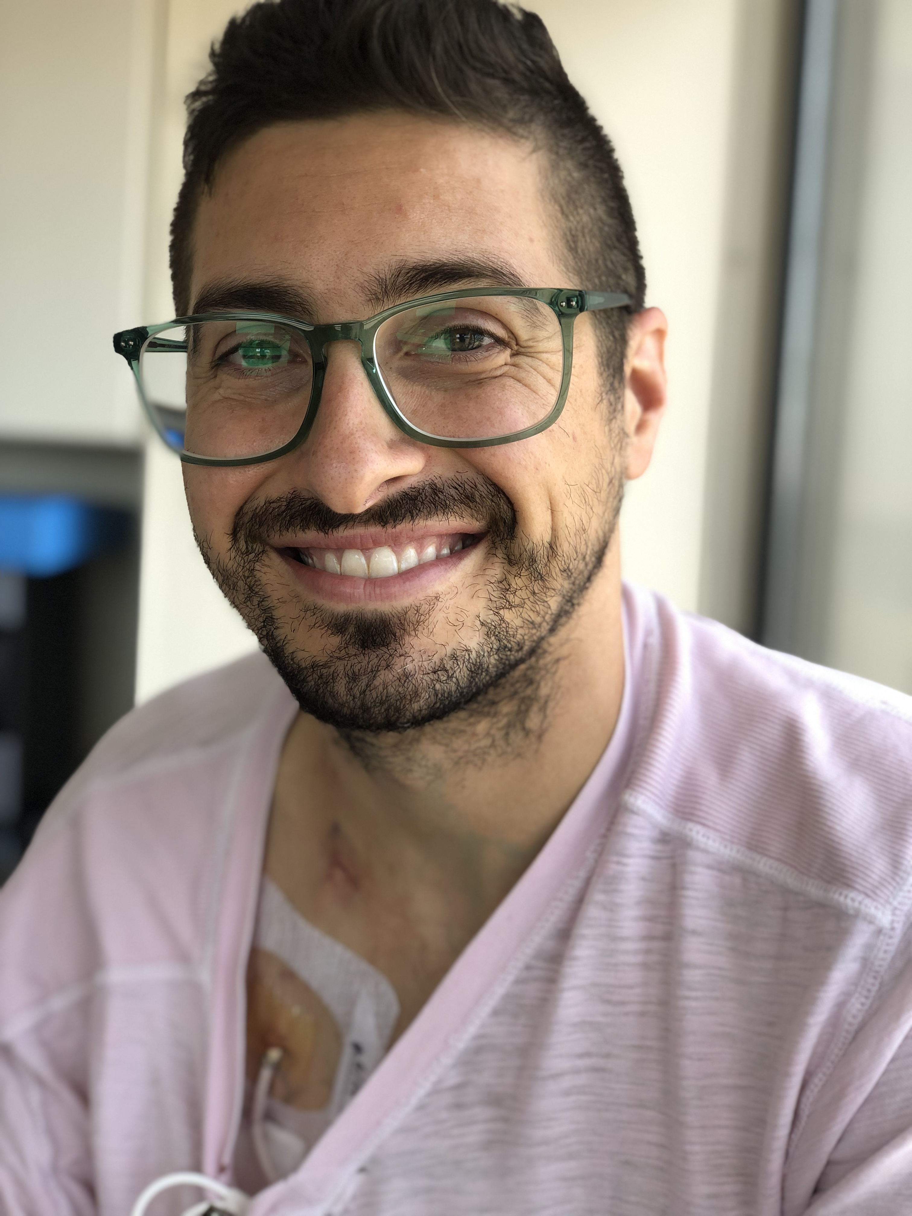 Young man with glasses and a pink shirt