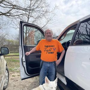 AML, man, glasses, beard, orange shirt, dog