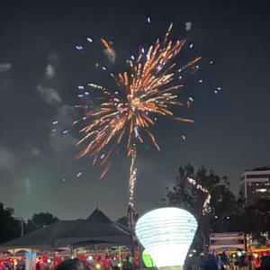Light The Night event with white lantern and fireworks honoring blood cancer survivor