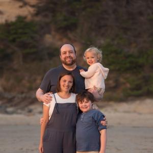family impacted by blood cancer leukemia standing on the beach