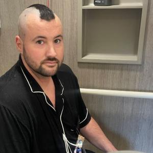 leukemia patient wearing a black shirt in the hospital receiving treatment