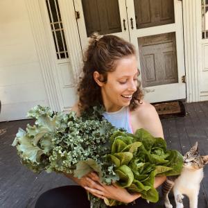 non-Hodgkin lymphoma survivor with green plant and cute cat