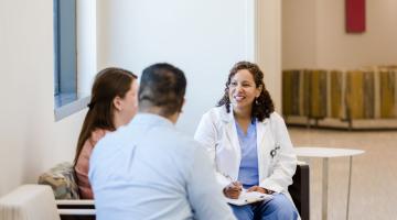 Healthcare professional speaking to patient