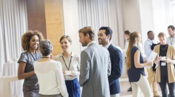 Professionals speaking with eachother at a conference