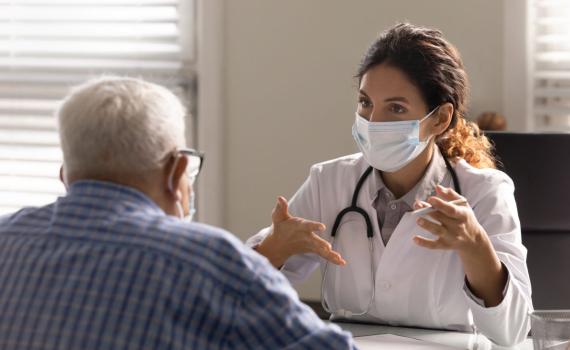 doctor speaking to male patient