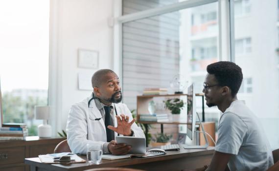 Doctor talking to young adult