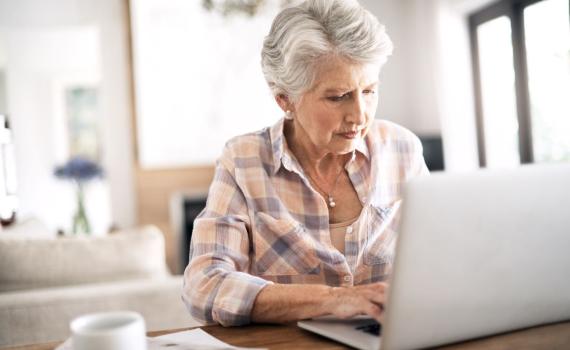 Woman watching webcast on laptop