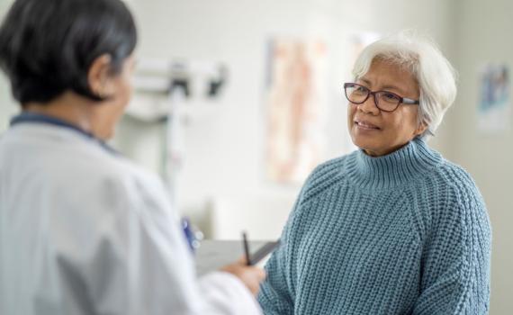 Elderly woman speaking with her doctor