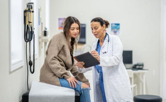 Healthcare provider with patient in exam room