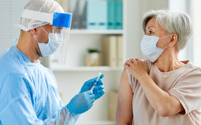 image of woman getting a vaccination shot
