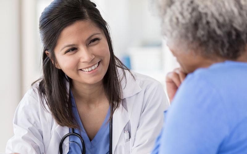 Image of caregiver speaking with a patient