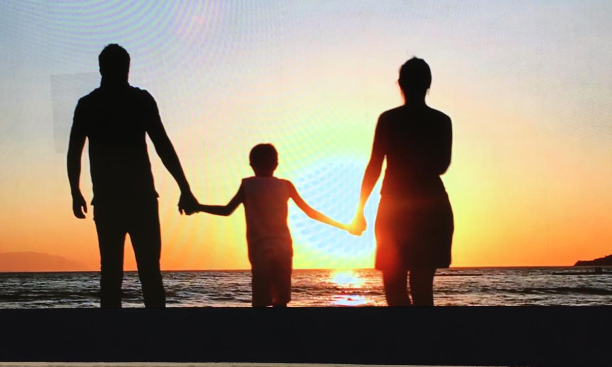 family walking in sunset