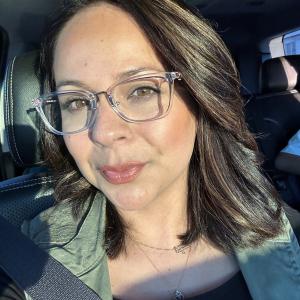 young, hispanic woman with glasses