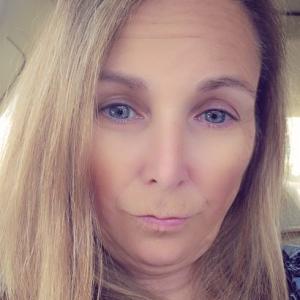 white woman with long blond hair and pink lipstick