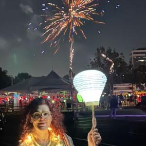 Light The Night event with white lantern and fireworks honoring blood cancer survivor