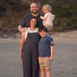 family impacted by blood cancer leukemia standing on the beach