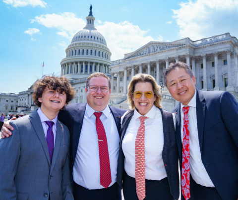 four people standing in front of congress