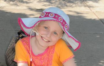 Maddy smiling, wearing a floppy hat