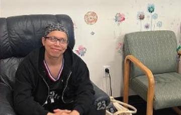 young blood cancer patient sitting in chair