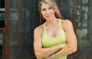 extremely fit middle aged white woman in lime green tank and shorts