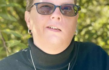 chronic myeloid leukemia, wearing dark colored shirt with glasses 