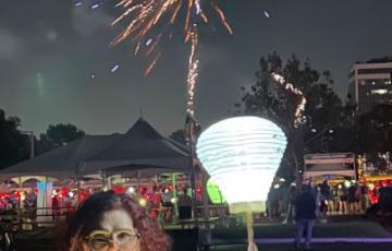 Light The Night event with white lantern and fireworks honoring blood cancer survivor
