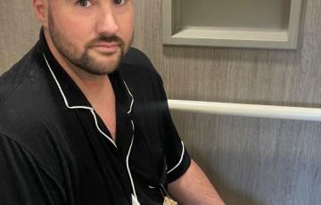 leukemia patient wearing a black shirt in the hospital receiving treatment