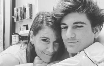 Michael and Ashlee black and white photo of Mom with three earrings in right ear and teenage son with stylish hair in a hospital room